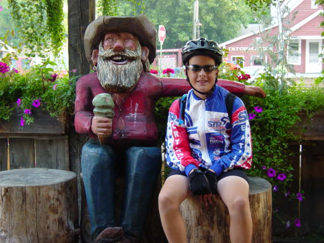 Photo: Young cyclist visits with a local at Methow ice cream shop. 