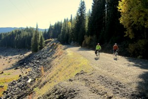 Cyclists ride along the nearly dry Keechelus lake bed in the fall.