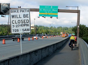 Cyclists pass construction zone Monday morning...
